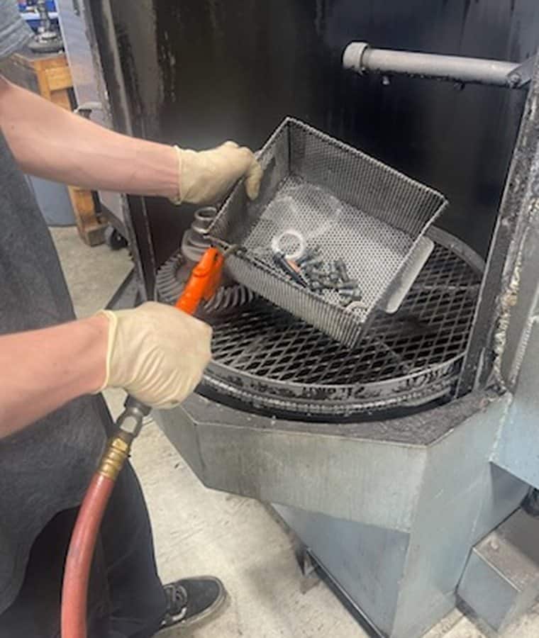 Differential parts being cleaned in the hot tank parts washer
